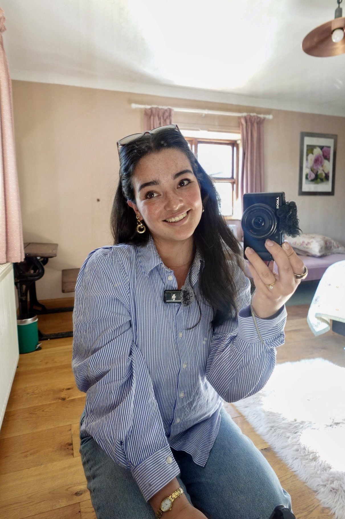 Abril, founder of Arrel Marketing, smiling with her camera